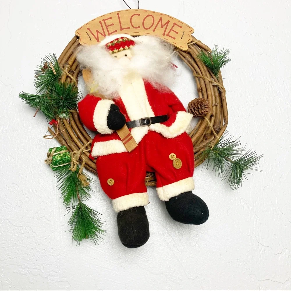 Christmas wreath with stuffed Santa Claus